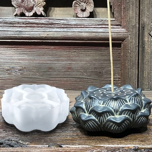 Detailed lotus silicone mold and finished incense holder on rustic wooden surface