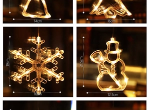 Detail view of warm white Christmas LED hanging lights in bell and snowflake shapes