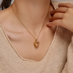 S925 sterling silver gold heart necklace with pink zircon gemstone worn by a model