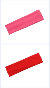 Detailed close-up of soft pink and red athletic sweatbands with wide elastic design