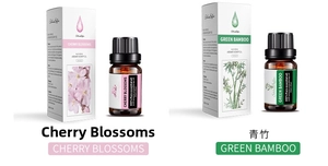 Detail view of 10ml cherry blossom and green bamboo essential oils in amber glass bottles