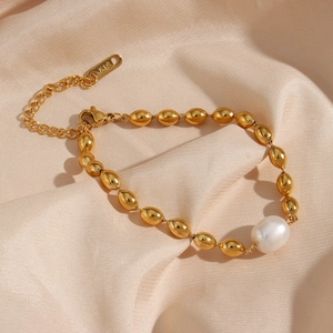 Elegant 18K gold-plated beaded bracelet with a white oval pearl on pink silk background