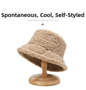 Close-up of khaki lamb wool bucket hat featuring thick grainy teddy fleece texture