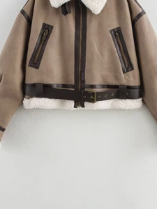 Detail of vintage brown faux suede shearling jacket with white fur lining and belt
