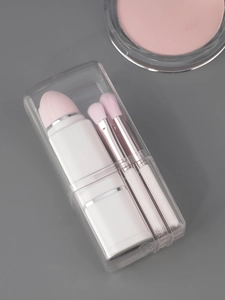 Detail of 8-in-1 portable makeup brush set with pearly white handles and pink bristles