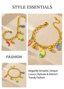 Detailed view of gold chain bracelet with enamel pepper, corn, and eggplant vegetable charms