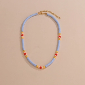 Detail of colorful heishi bead necklace with adjustable lobster clasp on beige background