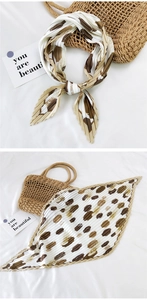Detail of pleated silk scarf with abstract earth tone spots and artistic texture