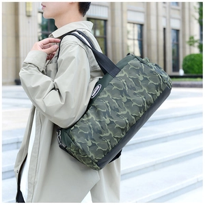 Detail of camouflage travel duffel bag with durable wide shoulder strap and fashion label