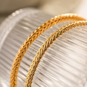 Polished 18K gold plated stainless steel wheat chain necklace with a woven texture