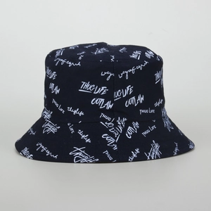 Close-up detail of black bucket hat featuring white graffiti style typography and patterns