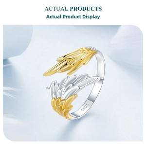 Detailed macro view of S925 sterling silver stamp on bicolor angel wing open ring
