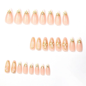 Pink almond press-on nails with 3D gold stars and relief flowers on white background