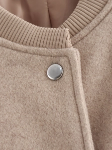 Detail view of khaki tweed jacket featuring ribbed knit collar and silver metal button