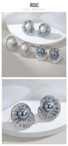 Macro detail of sunburst zircon studs with white, gray-blue, and sky-blue pearls