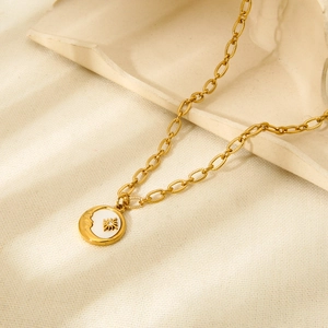 Close-up of 18K gold plated stainless steel necklace with sun and moon shell pendant