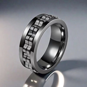 Macro view of dark stainless steel spinner ring with gear chain texture and polished edge