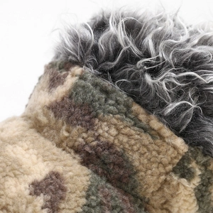 Macro detail of camouflage sherpa fabric and grey faux fur trim on a baseball cap