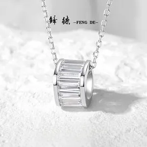 Macro detail of S925 silver necklace with baguette-cut zircon cylinder pendant