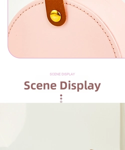 Pink round leather jewelry box with brown handle and golden buckle detail display