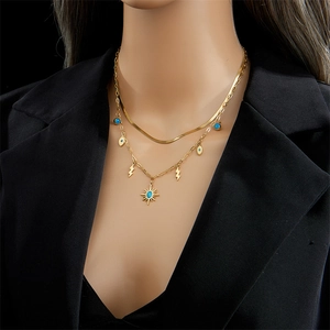 Layered gold necklace featuring turquoise evil eye, lightning, and starburst pendants