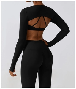 Detail of black yoga set featuring open back cutout top and high waist leggings for fitness