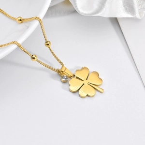 Titanium steel bead necklace with gold clover pendant and CZ crystal on silk fabric