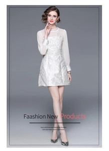 Detail of elegant white lace dress with floral embroidery and rhinestone neckline