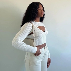 Detail of the white ribbed knit texture and slim-fit cut on this two-piece sweater set