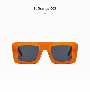Detail of bright orange rectangular sunglasses with dark lenses and metal hinges
