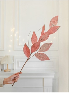 Close-up of a pink velvet artificial branch with glitter leaves for Christmas tree decor