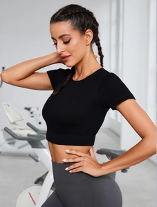 Close-up of black ribbed knit short sleeve yoga crop top for fitness and pilates