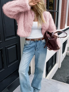 Close-up of a stylish pink faux fur short jacket featuring a plush texture and collarless cut