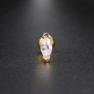 Macro detail of marquise-cut cubic zirconia earring with gold screw back and steel post