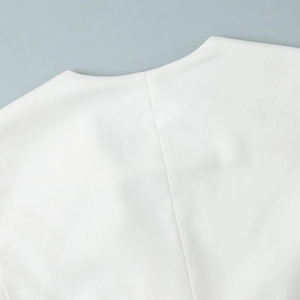 Close-up of V-neck stitching and premium woven fabric texture on a white summer vest set