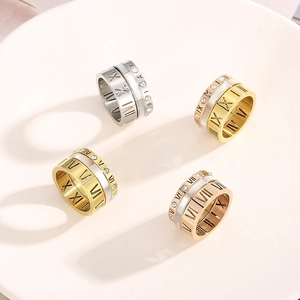 Detailed view of triple-layered Roman numeral rings with crystal inlay and shell finish