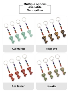 Detail view of heart-shaped natural crystal keychains in aventurine, tiger eye, and jasper