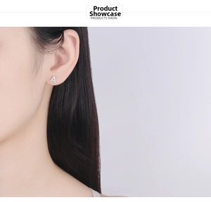 Detail shot of a s925 silver letter A stud earring with pavé zircon on woman ear