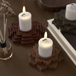 Zen style lotus and geometric resin candle holders with white candles in warm lighting