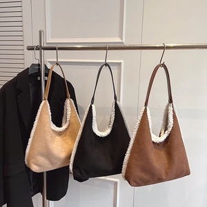Three plush shoulder tote bags in brown, black, and camel with fuzzy sheep wool trim