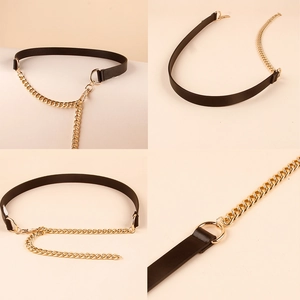 Close-up of stylish black leather and golden metal chain belt with polished circular rings