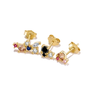Detailed macro shot of gold stud earrings with colorful cubic zirconia and S925 hallmark