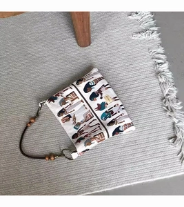 Detail of vintage Pharaoh jacquard tote bag with wooden bead charm and dark handles