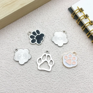 Detail of DIY cat and dog paw print alloy pendants showing enamel colors and textures