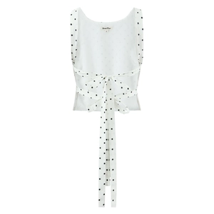 White polka dot sleeveless top featuring a stylish back bow tie design on white background