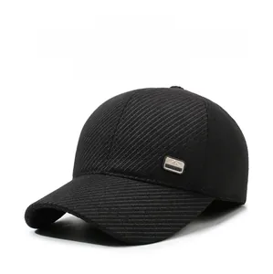 Detail of black winter baseball cap with thick twill fabric and metal mountain logo