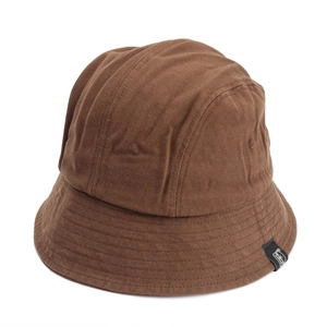 Close-up of a dark brown canvas bucket hat with reinforced stitching and logo label