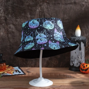 Halloween bucket hat with gothic cat and moon patterns on a dark wooden background