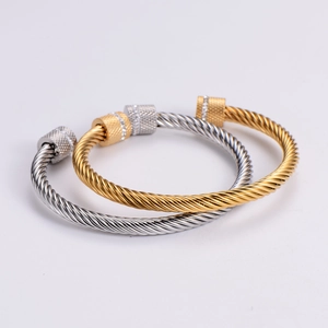 Set of gold and silver cable twist open bangles with knurled diamond-set ends