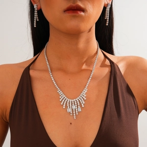 Silver fringe necklace and tassel earrings with sparkling crystals on a model